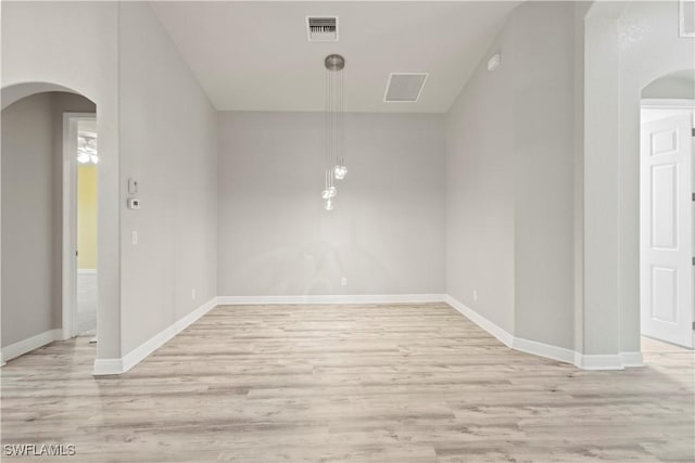 unfurnished room with light wood-type flooring