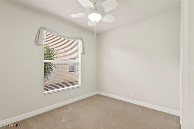 unfurnished room featuring ceiling fan and light carpet