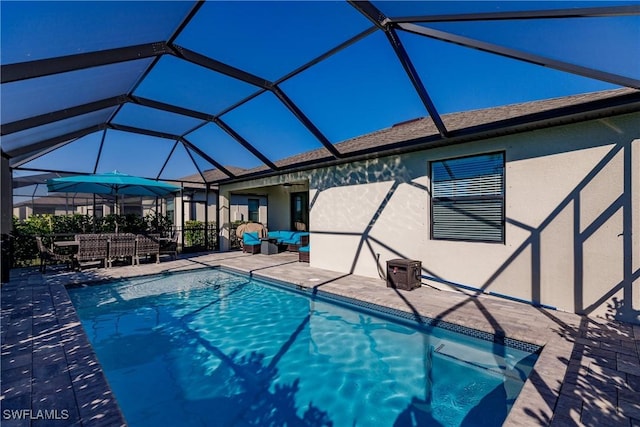 view of pool featuring a patio and glass enclosure