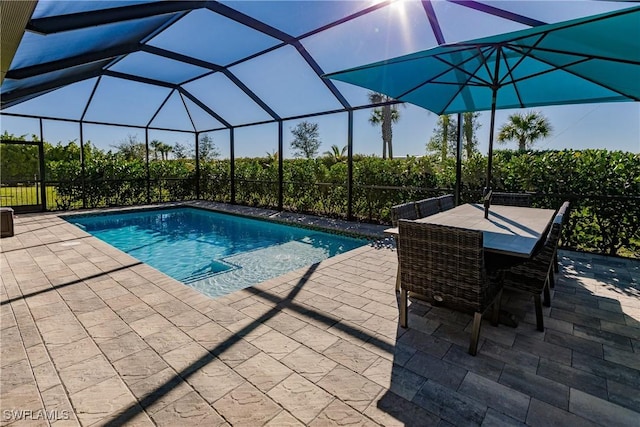 view of pool featuring a patio area and glass enclosure