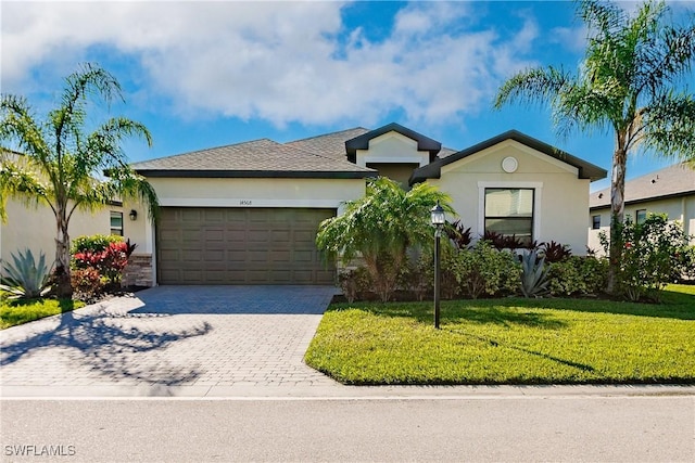 single story home featuring a front lawn and a garage