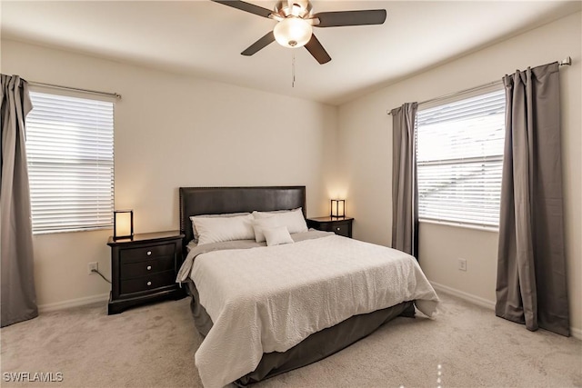 carpeted bedroom with multiple windows and ceiling fan