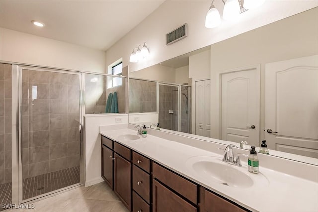 bathroom featuring vanity, tile patterned floors, and a shower with shower door