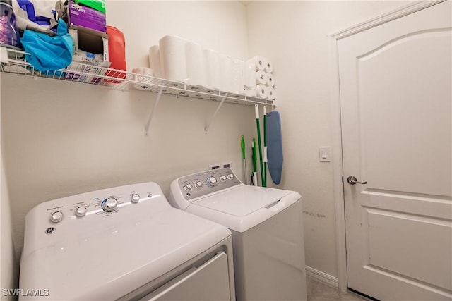 clothes washing area with washing machine and clothes dryer