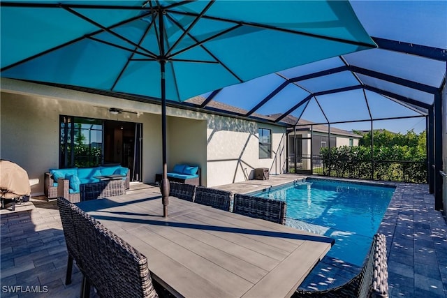 view of pool featuring ceiling fan, a lanai, a patio, and outdoor lounge area