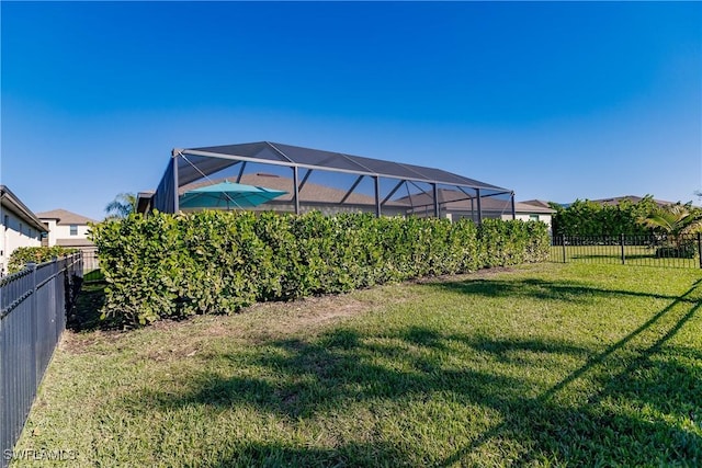 view of yard with glass enclosure