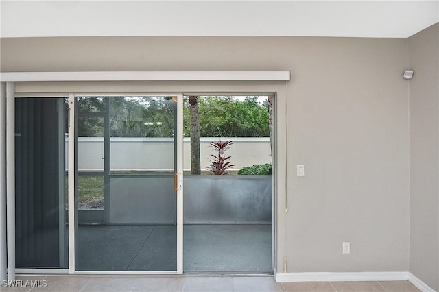 8681 Athena Ct, Lehigh Acres, FL 33971 - doorway featuring baseboards and tile patterned flooring
