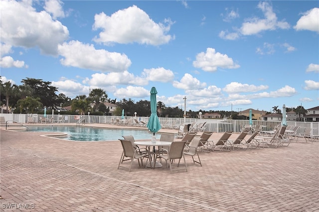 8681 Athena Ct, Lehigh Acres, FL 33971 - community pool featuring a patio