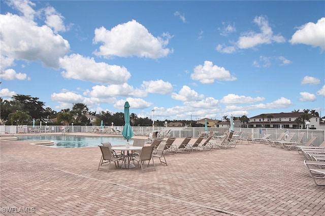8681 Athena Ct, Lehigh Acres, FL 33971 - community pool with a patio area