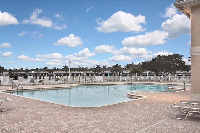 8681 Athena Ct, Lehigh Acres, FL 33971 - community pool with a patio area