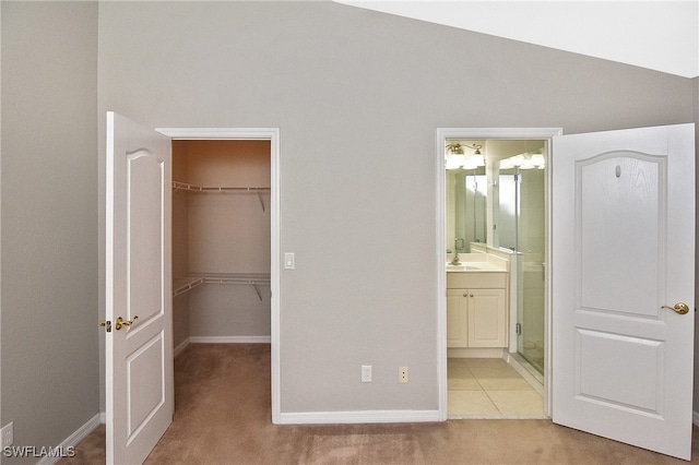 8681 Athena Ct, Lehigh Acres, FL 33971 - unfurnished bedroom with a spacious closet, carpet flooring, a sink, a closet, and baseboards