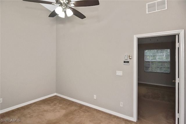 8681 Athena Ct, Lehigh Acres, FL 33971 - spare room featuring carpet flooring, baseboards, and ceiling fan