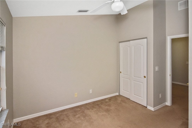 8681 Athena Ct, Lehigh Acres, FL 33971 - unfurnished bedroom featuring carpet floors, a closet, baseboards, and ceiling fan