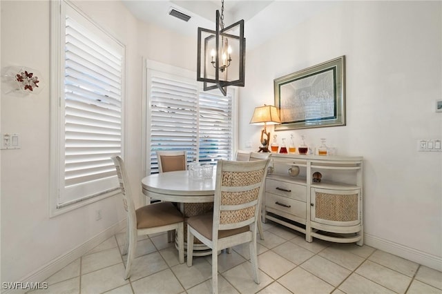 dining room with an inviting chandelier and light tile patterned floors