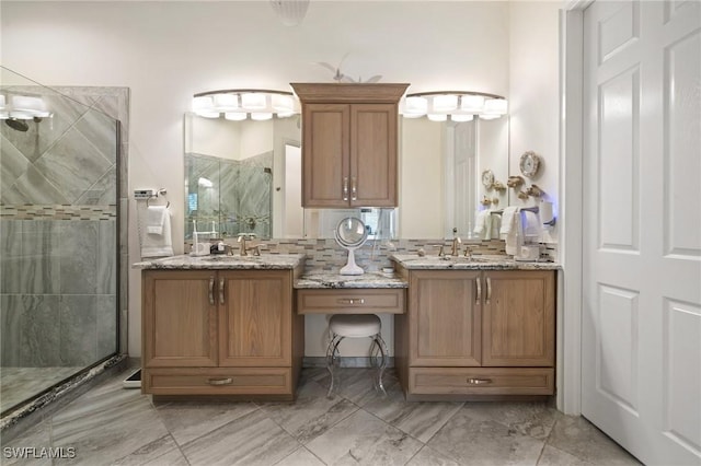 bathroom featuring an enclosed shower and vanity