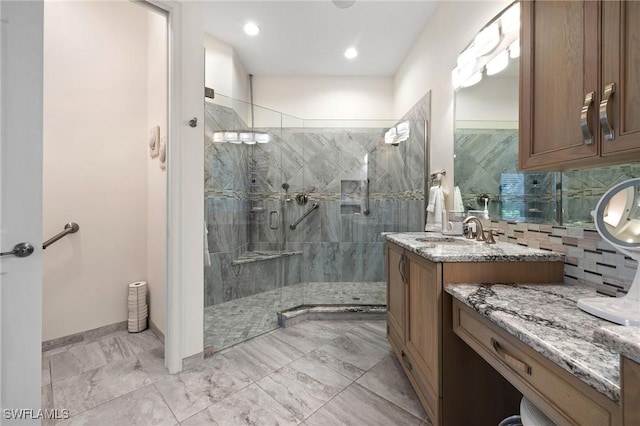 bathroom featuring vanity, an enclosed shower, and decorative backsplash