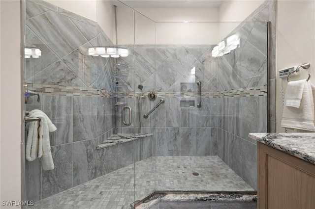 bathroom with a shower with door and vanity