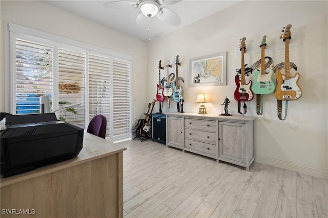 home office with ceiling fan and light hardwood / wood-style flooring