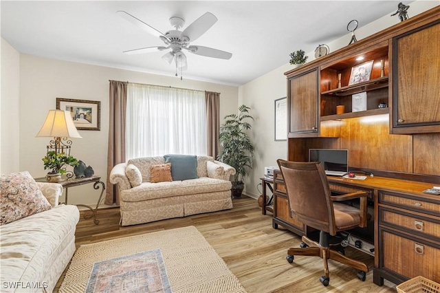 office space featuring ceiling fan, plenty of natural light, light hardwood / wood-style flooring, and built in desk