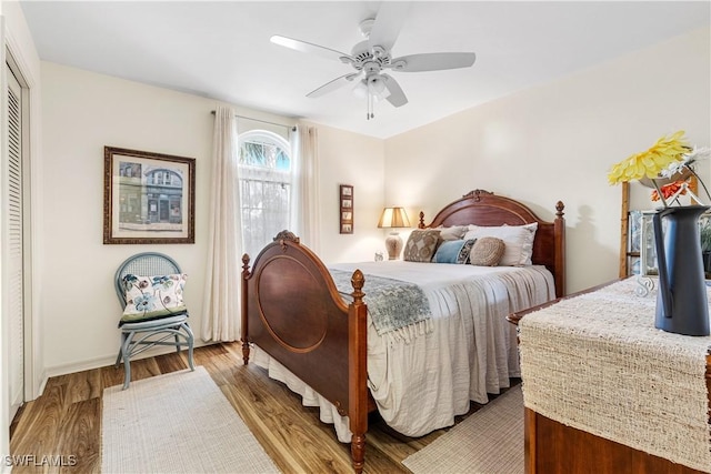 bedroom featuring ceiling fan, a closet, and light hardwood / wood-style flooring