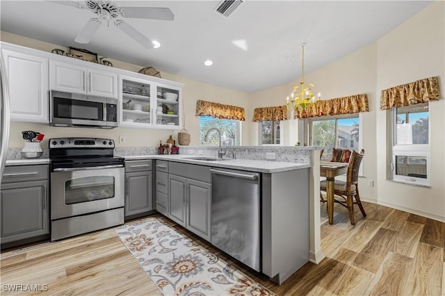 kitchen featuring stainless steel appliances, white cabinetry, and gray cabinets