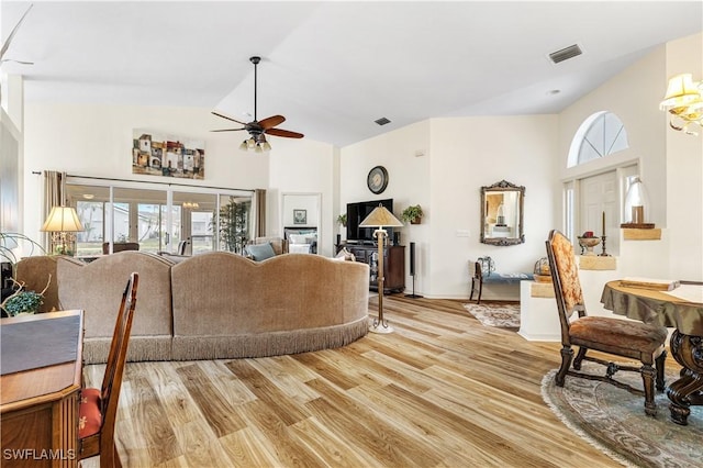 living room with light wood-type flooring, ceiling fan, and a wealth of natural light