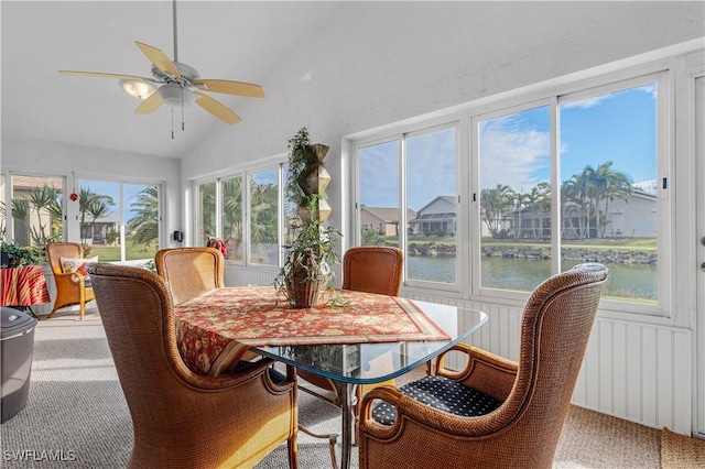 sunroom featuring a water view, vaulted ceiling, plenty of natural light, and ceiling fan