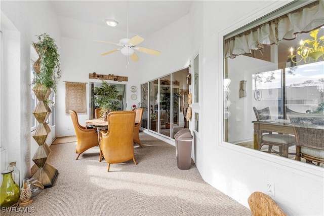 sunroom with ceiling fan and lofted ceiling