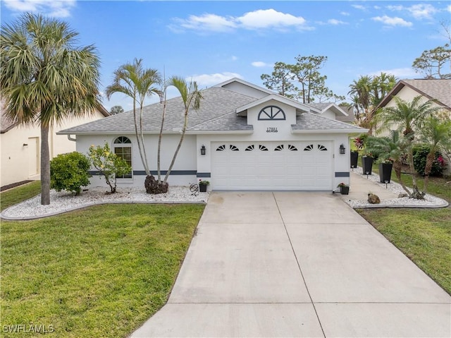 view of front of property featuring a garage and a front lawn