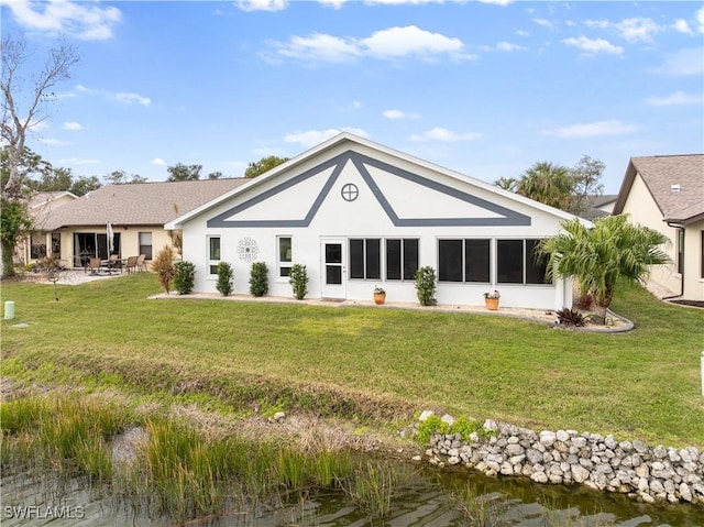 rear view of property featuring a yard