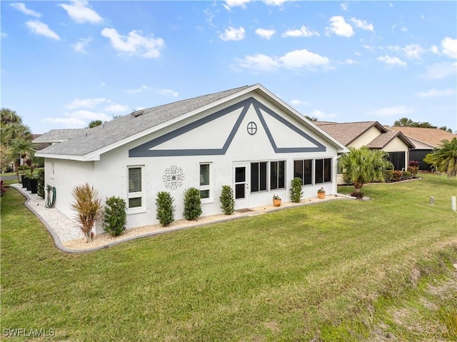 rear view of property with a lawn