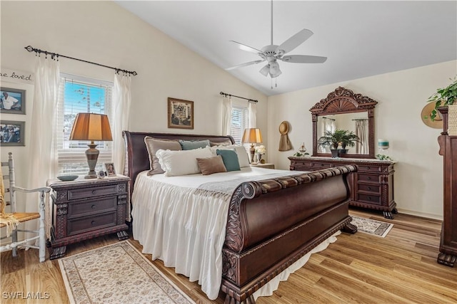 bedroom with ceiling fan, light hardwood / wood-style floors, and lofted ceiling