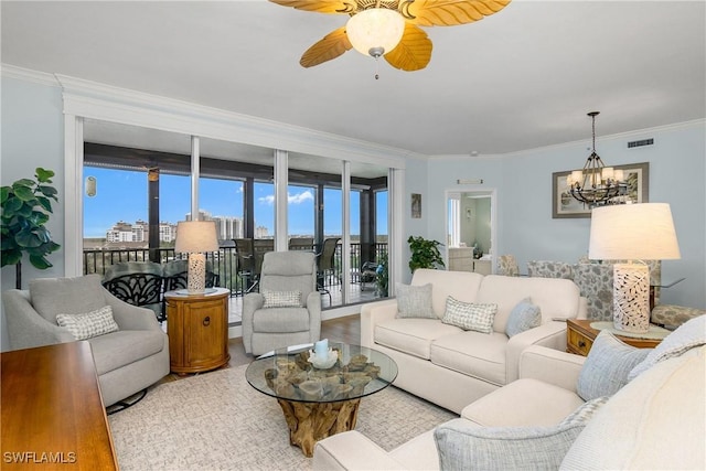 living room featuring crown molding, light hardwood / wood-style floors, and ceiling fan with notable chandelier