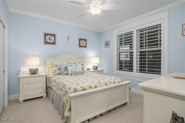 carpeted bedroom featuring crown molding and ceiling fan