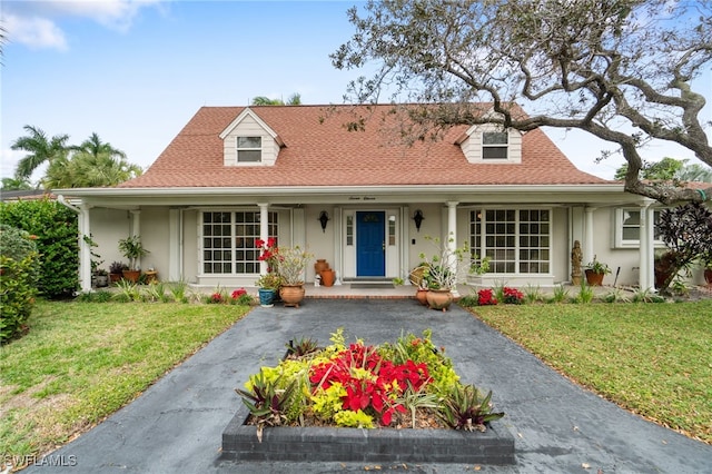 view of front of property with a front yard and covered porch