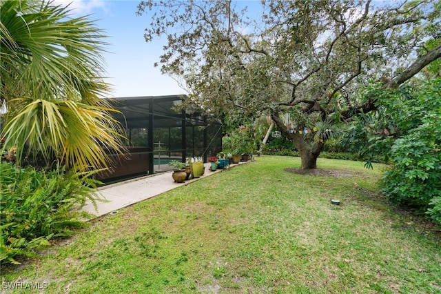 view of yard featuring a pool and a lanai