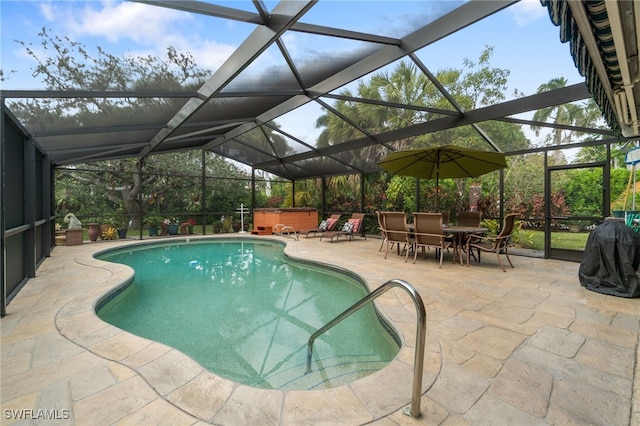 view of swimming pool featuring a hot tub, a patio area, and glass enclosure