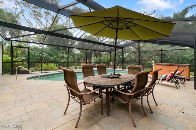 view of patio / terrace with a swimming pool with hot tub and a lanai