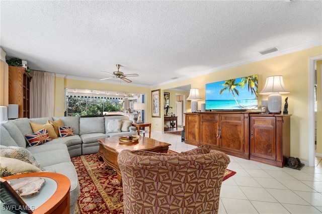 tiled living room featuring a textured ceiling, ornamental molding, and ceiling fan