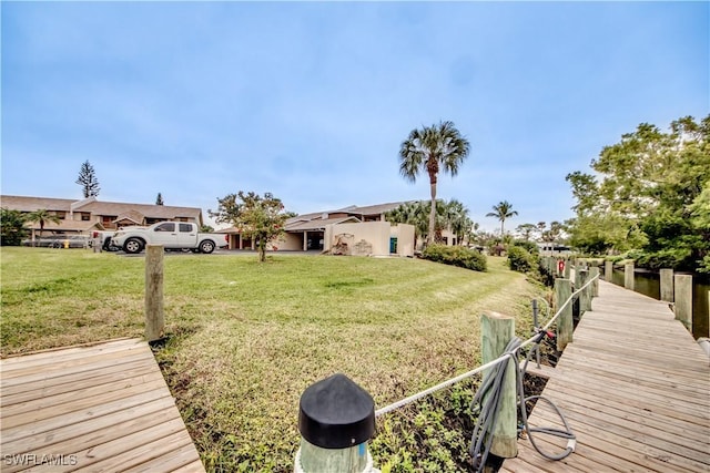 view of dock with a yard