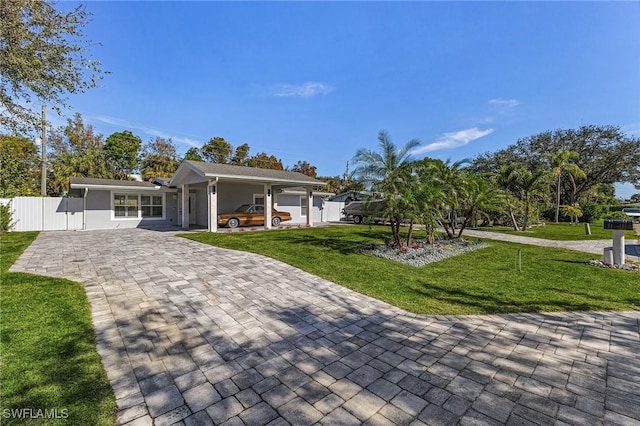 view of front facade with a front lawn and a carport