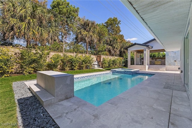 view of swimming pool with a patio and an in ground hot tub