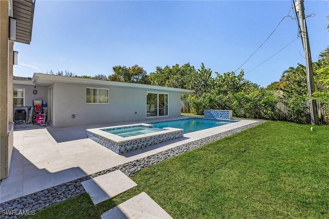 view of swimming pool with an in ground hot tub, a yard, and a patio area