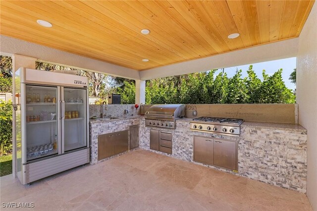 view of patio featuring a grill, sink, and exterior kitchen