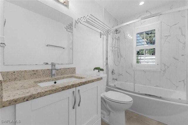 full bathroom featuring enclosed tub / shower combo, vanity, and toilet