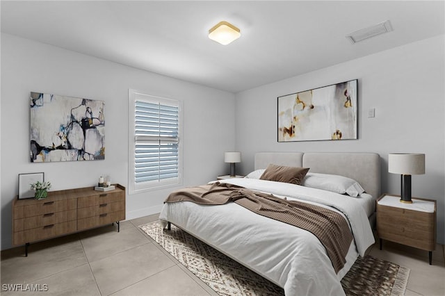 bedroom with light tile patterned floors