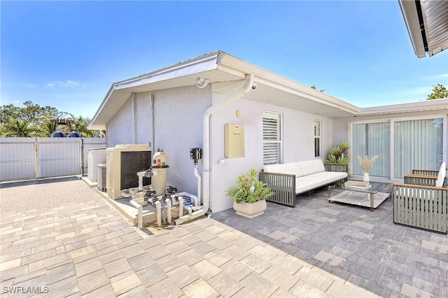 rear view of house with an outdoor hangout area, a patio, and central air condition unit