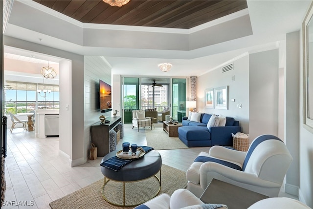 living room with ceiling fan with notable chandelier, crown molding, and wood ceiling