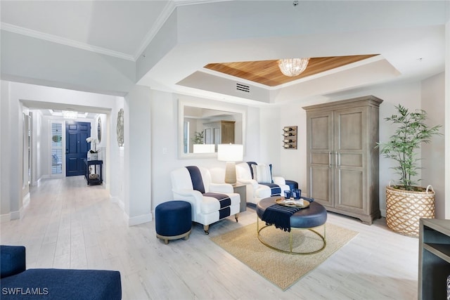 living area featuring an inviting chandelier, light hardwood / wood-style floors, wooden ceiling, a raised ceiling, and ornamental molding