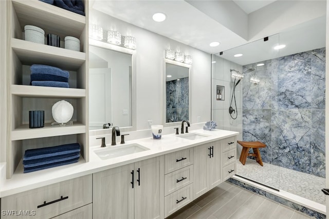 bathroom with vanity and tiled shower